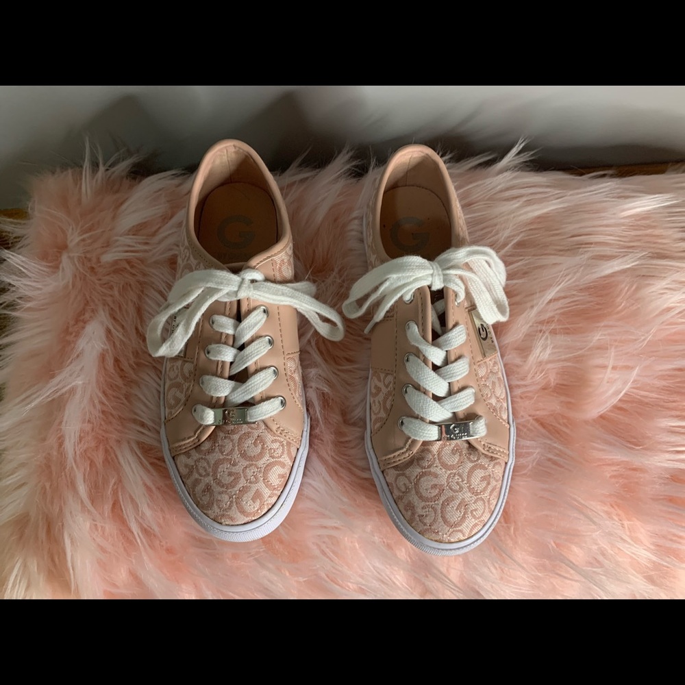 The brand is Guess. They are a light pink beige color with pink G.